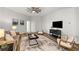 Comfortable living room with modern furniture, ceiling fan, and bright light at 135 Emerald Ln, Roswell, GA 30075