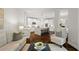 Open-concept living room and kitchen with white cabinets, a large island, and hardwood floors for a spacious atmosphere at 135 Emerald Ln, Roswell, GA 30075