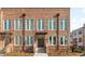 Beautiful brick townhouse exterior showcasing large windows and a welcoming front entrance with well-kept landscaping at 137 Devore Rd, Alpharetta, GA 30009