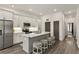 Stylish kitchen island with bar stool seating, stainless appliances, subway tile backsplash, and white cabinets at 137 Devore Rd, Alpharetta, GA 30009