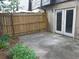 Enclosed patio with a wooden fence, french doors to the home and exterior lighting at 1818 Ashborough Cir # E, Marietta, GA 30067