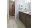 Bathroom featuring a tile shower, stylish vanity, and built-in storage at 1818 Ashborough Cir # E, Marietta, GA 30067