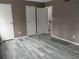Bedroom with wood-look floors and access to closet and stairwell at 1818 Ashborough Cir # E, Marietta, GA 30067