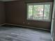 Bedroom with wood-look floors, neutral paint, and window views at 1818 Ashborough Cir # E, Marietta, GA 30067