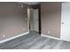 Bedroom with wood-look floors, closet, and neutral paint offering a clean aesthetic at 1818 Ashborough Cir # E, Marietta, GA 30067