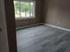 A bright bedroom showcasing wood-look floors, a window, and neutral paint at 1818 Ashborough Cir # E, Marietta, GA 30067