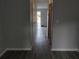 Hallway with updated gray walls, and wood-look floors leading to the home's entrance at 1818 Ashborough Cir # E, Marietta, GA 30067