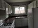 Bright kitchen with white appliances and ample countertop space by the window at 1818 Ashborough Cir # E, Marietta, GA 30067