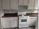 Kitchen offers white appliances, plenty of cabinet space and laminate countertops at 1818 Ashborough Cir # E, Marietta, GA 30067