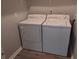 Laundry room with modern washer and dryer units, and updated flooring at 1818 Ashborough Cir # E, Marietta, GA 30067