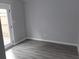 A room with neutral paint and wood-look floors and a door to the patio at 1818 Ashborough Cir # E, Marietta, GA 30067