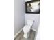 Powder room with modern toilet, wood-look floors and decorative wall art at 1818 Ashborough Cir # E, Marietta, GA 30067