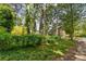 Backyard trees surround a cottage-style home at 1876 Madrona Street Nw St, Atlanta, GA 30318