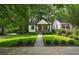 Beautifully landscaped home with manicured lawn and gray stone walkway at 1876 Madrona Street Nw St, Atlanta, GA 30318