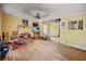 Open-concept living room with hardwood floors, a ceiling fan, and a decorative fireplace at 1876 Madrona Street Nw St, Atlanta, GA 30318