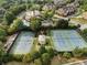 An aerial view showcases the community tennis courts, pool, and clubhouse surrounded by lush trees and landscaping at 6430 Banbury Se Ct, Mableton, GA 30126