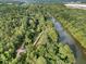 An aerial view displays the serene river running through a green forest with a bridge crossing through the landscape at 6430 Banbury Se Ct, Mableton, GA 30126