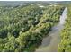 An aerial view displays the serene river running through a green forest with a bridge crossing through the landscape at 6430 Banbury Se Ct, Mableton, GA 30126