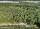 An aerial view showcases a lush, dense forest landscape, and a paved entryway to a nature trail at 6430 Banbury Se Ct, Mableton, GA 30126