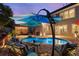 Inviting backyard pool with an umbrella, outdoor seating and a covered pergola for relaxing gatherings at 6430 Banbury Se Ct, Mableton, GA 30126