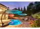 Backyard oasis featuring a pool, lounge chairs, manicured landscaping, and ample privacy at 6430 Banbury Se Ct, Mableton, GA 30126