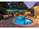 Stunning backyard with a pool, patio, lounge area, pergola, and mature landscaping with lighting at 6430 Banbury Se Ct, Mableton, GA 30126