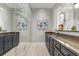 Modern bar area with sleek cabinetry, granite countertops, mirrored backsplash, and elegant fixtures at 6430 Banbury Se Ct, Mableton, GA 30126