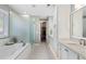 A luxurious bathroom is equipped with a soaking tub and a glass-enclosed shower at 6430 Banbury Se Ct, Mableton, GA 30126