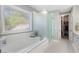 Bathroom boasts a soaking tub, frosted glass shower, and walk-in closet at 6430 Banbury Se Ct, Mableton, GA 30126
