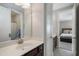 Modern bathroom with dual vanity, white countertop, and a view into the bedroom at 6430 Banbury Se Ct, Mableton, GA 30126