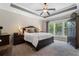 Well-lit bedroom with tray ceiling and furnishings at 6430 Banbury Se Ct, Mableton, GA 30126