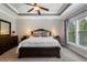 Bedroom features a tray ceiling, neutral colored walls, and a large window for natural light at 6430 Banbury Se Ct, Mableton, GA 30126