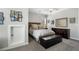 Comfortable bedroom with soft gray walls, carpet, a queen bed, and modern decorations at 6430 Banbury Se Ct, Mableton, GA 30126