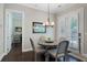 Bright dining area with a round table, four chairs, and access to the outdoor area through shuttered glass doors at 6430 Banbury Se Ct, Mableton, GA 30126