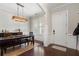 Elegant dining room showcases a modern chandelier, plantation shutters, and wainscoting for a sophisticated touch at 6430 Banbury Se Ct, Mableton, GA 30126