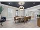 Dining area featuring modern decor, including a striking light fixture and large windows with shutters at 6430 Banbury Se Ct, Mableton, GA 30126