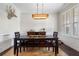 Dining room features a dark wood table, a rustic light fixture, and stylish decor for memorable gatherings at 6430 Banbury Se Ct, Mableton, GA 30126