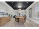 Elegant dining room with wood floors, a modern chandelier, and lots of natural light from shuttered windows at 6430 Banbury Se Ct, Mableton, GA 30126