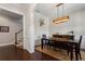 Spacious dining room offering wood floors, elegant wainscoting, and modern lighting for a refined dining experience at 6430 Banbury Se Ct, Mableton, GA 30126