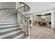 Bright entryway features a curved staircase and views of a dining room with a modern chandelier at 6430 Banbury Se Ct, Mableton, GA 30126