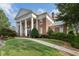 Elegant brick building featuring a grand entrance with white columns and manicured landscaping at 6430 Banbury Se Ct, Mableton, GA 30126