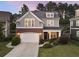 Charming two-story home featuring a brick facade, lush landscaping, and a two-car garage at 6430 Banbury Se Ct, Mableton, GA 30126