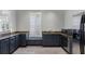 Modern kitchenette with stainless steel appliances, granite countertops and lots of natural light at 6430 Banbury Se Ct, Mableton, GA 30126