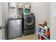 Functional laundry room with modern appliances and storage shelves at 6430 Banbury Se Ct, Mableton, GA 30126