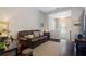 Cozy living room with carpet, neutral tones, and a view of the staircase at 6430 Banbury Se Ct, Mableton, GA 30126