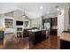 Inviting living space with dark cabinets, a granite countertop island, and a cozy seating area by the fireplace at 6430 Banbury Se Ct, Mableton, GA 30126