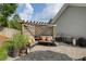 Stone patio with an outdoor living area under a pergola, and a stainless steel grill at 6430 Banbury Se Ct, Mableton, GA 30126