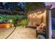 Relaxing patio with a pergola strung with decorative lighting, a sofa and plantings at 6430 Banbury Se Ct, Mableton, GA 30126