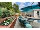 An in-ground pool is surrounded by comfortable outdoor seating, professional landscaping, and an outdoor grill at 6430 Banbury Se Ct, Mableton, GA 30126