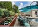 An in-ground pool is surrounded by comfortable outdoor seating, professional landscaping, and an outdoor grill at 6430 Banbury Se Ct, Mableton, GA 30126